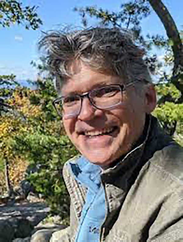 Photo of Dr. Bruce Cook with trees in the background