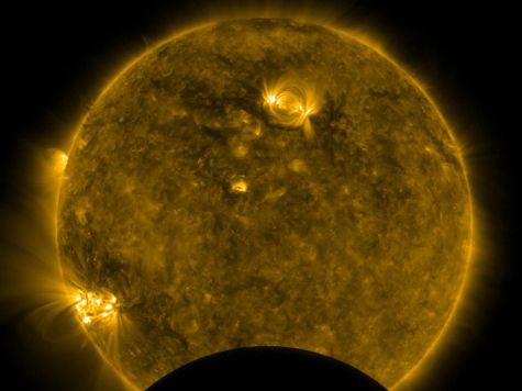 image of the dark shadow of the moon passing in front of the sun as seen by the 
Solar Dynamics Observatory
