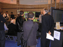 Various visitors to the NLR booth being briefed by Tom West, president and CEO of the NLR