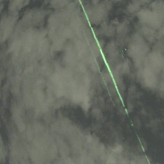 Image of ICESat-2 laser beam in clouds over Japan