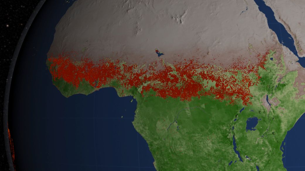 Image of central Africa showing a line of red dots that represent fires south of the Sahara from West Africa across to south of Egypt.