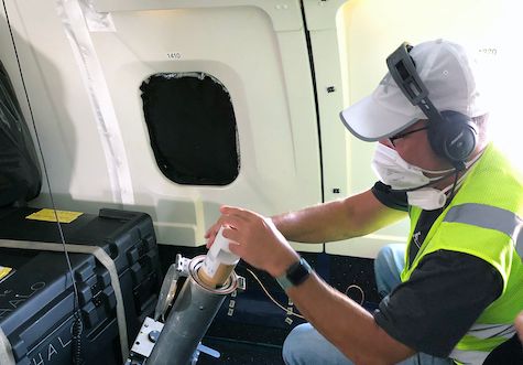 Photo of Lee Thornhill loading a dropsonde for launch from a NASA DC-8 aircraft 