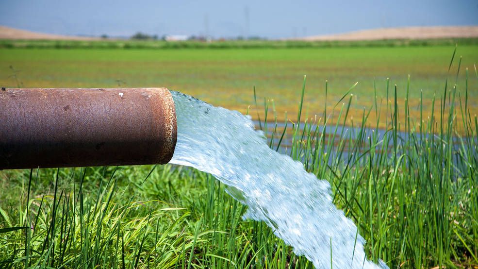 Photo of water running out of irrigation pipe