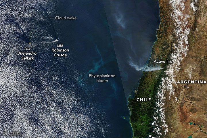 Smoke, cloud wakes, and a phytoplankton bloom formed a mosaic of natural phenomena off the coast of central Chile in this Aqua satellite natural-color image