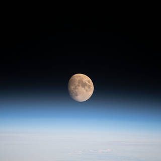 Image of moon over Earth's atmosphere
