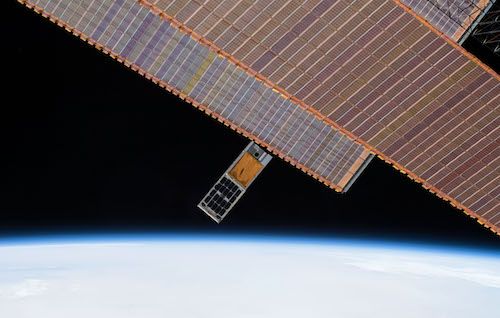 ISS photograph of HaloSat being deployed. Solar panels in the upper right are panels on the ISS.