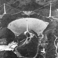 A black and white photo of the Arecibo Observatory