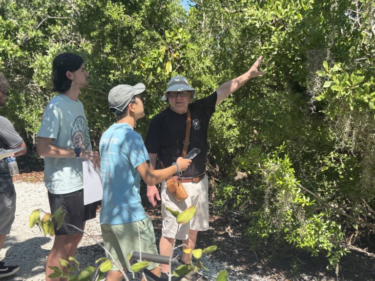 Nick Barbi showing students how to take spectral readings of vegetation